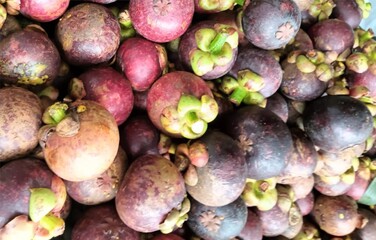 Fresh manggis or mangosteen fruit sale in the market for background.