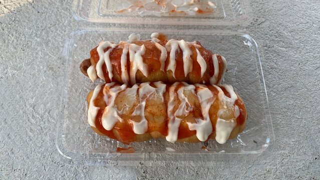 Sausage bread with sauce and mayonnaise. Roti sosej.
