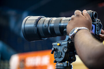 Close-up of a photographer using telephoto lens to captured a moment