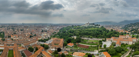 Aerial view of Brescia medieval castle, city center, city walls, bastions, vineyards in Lombardy...