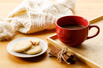 Cup of delicious hot chocolate, Cookies on wooden table background.