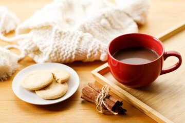 Cup of delicious hot chocolate, Cookies on wooden table background.