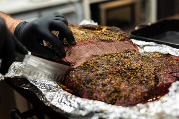 BBQ brisket about to be sliced with knife