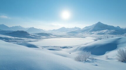 Fototapeta premium Snow-Covered Mountain Range with Frozen Lake and Bright Sun