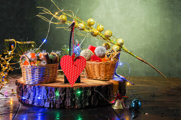Christmas composition with sweets and lights. Heart and sweets on the podium.