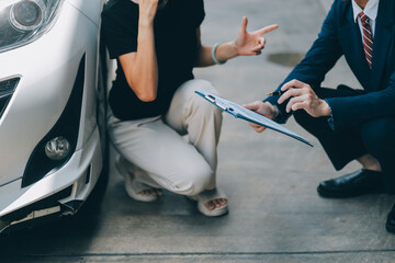 A young businesswoman is navigating car insurance options at her desk, considering premiums,...