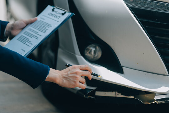 A young businesswoman is navigating car insurance options at her desk, considering premiums, deductibles, and coverage while understanding policies and managing claims efficiently.