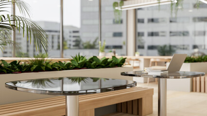 A table in a contemporary indoor setting features indoor plants, wooden benches, and a large window.