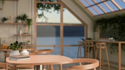 A close-up of a minimalist wooden table and armchair in a Scandinavian coffee shop.