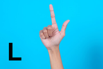 Finger Spelling the Alphabet in American Sign Language (ASL). The Letter L Over Blue Background
