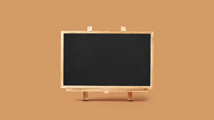 Blank wooden chalkboard on brown background. Learning and educational concept.