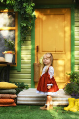 Little girl of two years old in a hat and a beautiful vintage dress. Beautiful little child walking in the garden