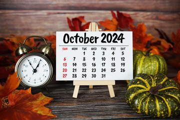October 2024 monthly calendar maple leaf decoration on wooden background