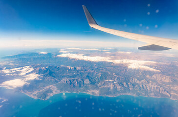 View from the airplane window of the mountains and sea resort with corals in Egypt, Sharm El Sheikh.Flight
