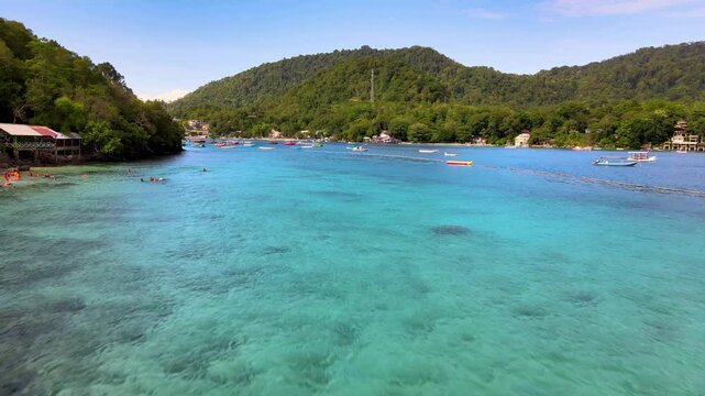 Idyllic Pier Stretching Over Emerald-Hued Waters