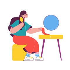 Woman sitting in front of a mirror brushing her hair