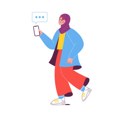Muslim woman walking and texting on the phone