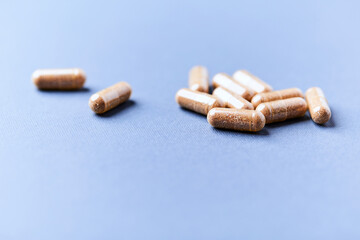Carnitine capsules. Concept for a healthy dietary supplementation. Bright paper background. Soft focus. Close up.	