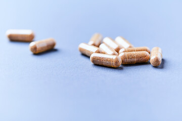 Carnitine capsules. Concept for a healthy dietary supplementation. Bright paper background. Soft focus. Close up.	