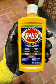 Bottle of Brasso chrome, brass, and stainless steel polish solution.