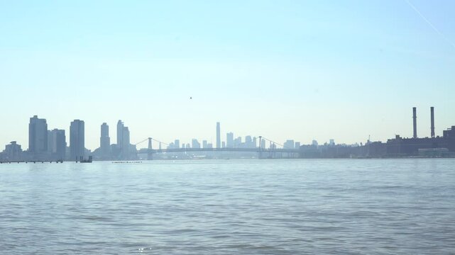 Williamsburg Bridge in the distance with a helicopter approaching