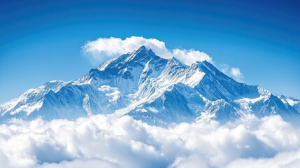 Obraz premium Majestic mountain peak rising above clouds in clear sky.