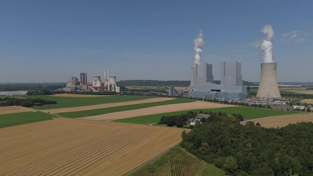 Two Big Cooling Towers Of Active Block Unit Of Neurath Power Station In Grevenbroich, Germany. Aerial Pullback Shot