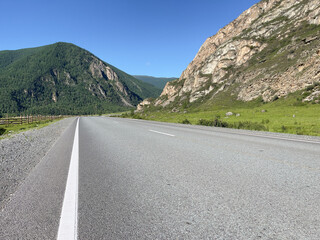 Naklejka premium Rural landscape road in the mountains, photo as background, digital image.