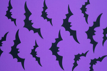 Abstract design featuring black bat silhouettes on a vibrant purple background