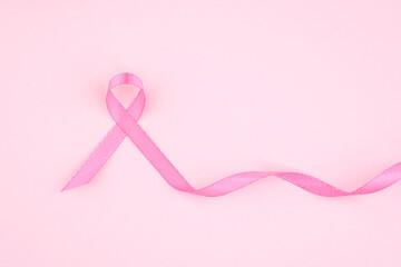 Awareness ribbon on a soft pink background promoting breast cancer awareness month