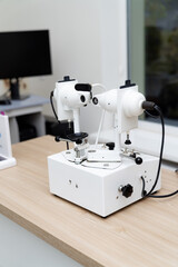 Ophthalmology tools on clinic countertop. A detailed setup of ophthalmology equipment on a clean countertop inside a clinic