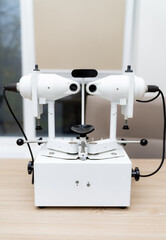 Eye exam lens machine for clinics. A high-tech optical lens machine is set up in a clinic for precise eye examinations and lens fitting for patients.