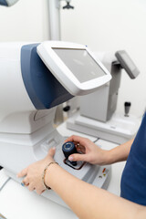 Eye examination equipment in a modern clinic. A healthcare professional operates advanced eye examination equipment in a well-lit clinic during