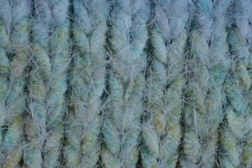 Macro texture of acrylic multicolored rainbow pastel crocheted winter clothing sweater as background, close-up of rainbow front surface, multicolored wool texture, crocheted front surface, part of sca