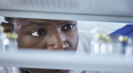 Scientist, stock and inventory in science lab for medical research, chemistry experiment or healthcare. Male person, storage and chemical for pharmaceutical test, analysis or mpox vaccine in hospital