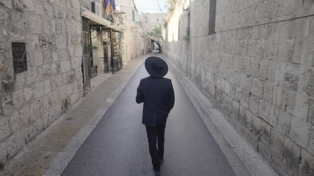 Orthodox Jew walking through alleyway in the Old City of Jerusalem, Israel