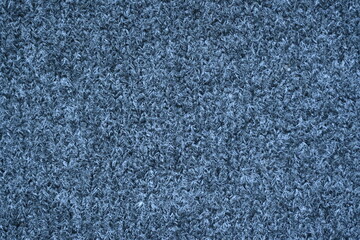 macro texture of woolen dark gray crocheted sweater as background, close-up of gray crocheted front surface, woolen texture of woolen wool, knitted front surface