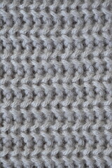 macro texture of woolen pastel crocheted sweater as background, close-up of brown crocheted front surface, woolen texture of woolen wool, trend pastel crocheted front surface