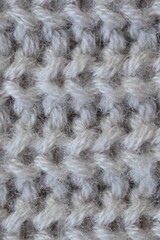 macro texture of woolen pastel crocheted sweater as background, close-up of brown crocheted front surface, woolen texture of woolen wool, trend pastel crocheted front surface