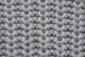 macro texture of woolen pastel crocheted sweater as background, close-up of brown crocheted front surface, woolen texture of woolen wool, trend pastel crocheted front surface