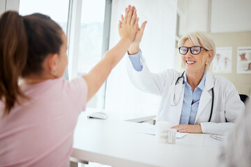 Woman, doctor and high five with girl at office for consultation, checkup and good news. People,...