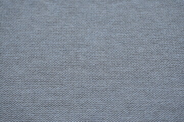 Macro texture of woolen brown crocheted sweater as background, close-up of beige crocheted front surface, woolen texture of woolen wool, crocheted front surface