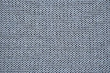 Macro texture of woolen brown crocheted sweater as background, close-up of beige crocheted front surface, woolen texture of woolen wool, crocheted front surface