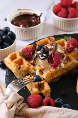still life Belgian waffles on a black round plate