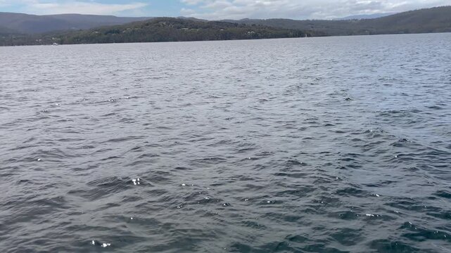 Moving across water of D'Entrecasteaux Channel towards distant shore of Tasmania from Bruny island, Australia