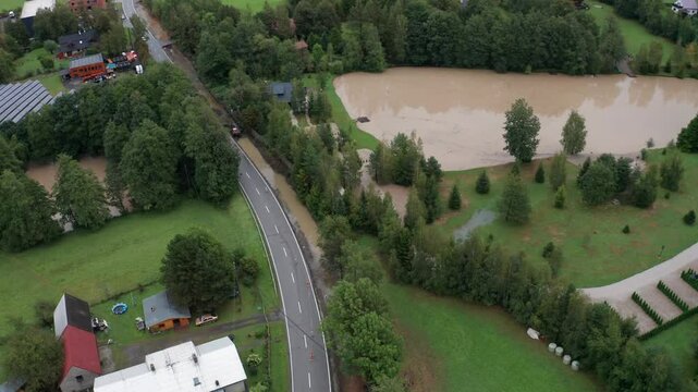 Drone shot of flooded road with lake