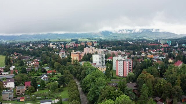 Drone shot of strong current river in the city under mountains