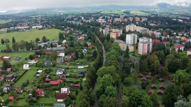 Drone shot of strong current river in the city under mountains