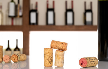 Wine corks are made of tree bark against the background of old wine bottles.
