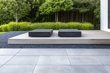 Obraz premium Modern outdoor patio with minimalist seating and lush greenery in a tranquil garden setting